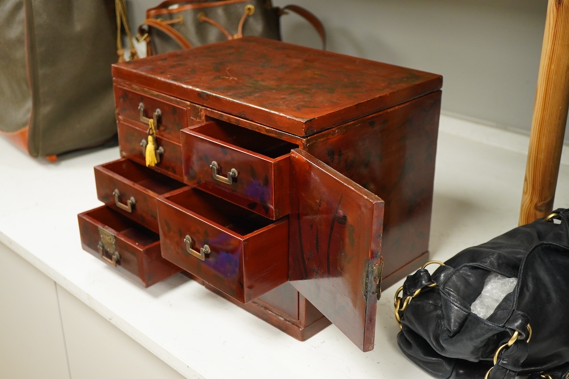 A Japanese floral lacquer table top cabinet, Taisho period, 36cm wide, the top panel is removable to form a twin pedestal cabinet